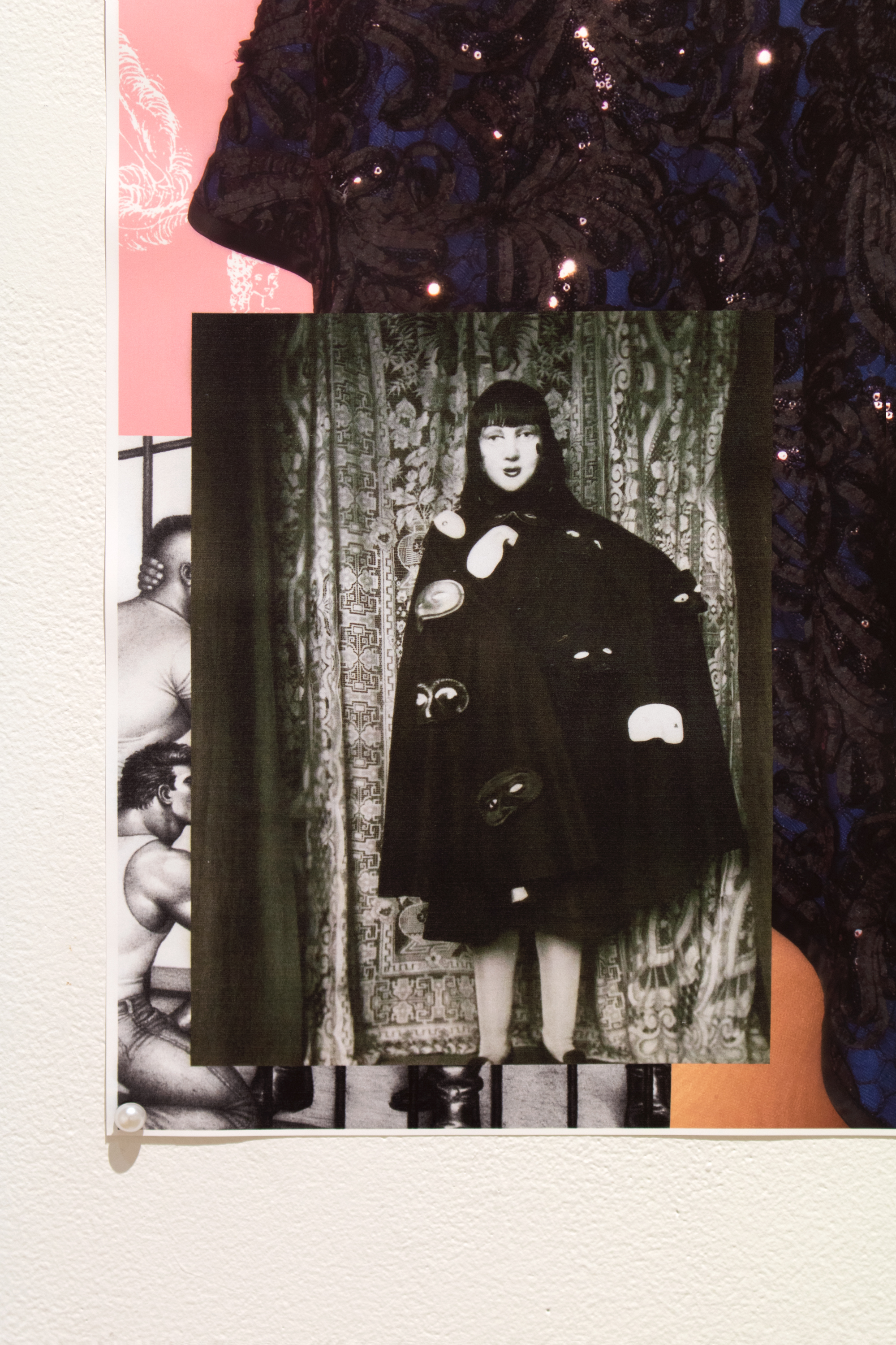 detail of 'before i die' piece featuring a photo of claude cahun in an outfit made of masks placed on top of a tom of finland artwork of prisoners giving police men oral sex through prison bars